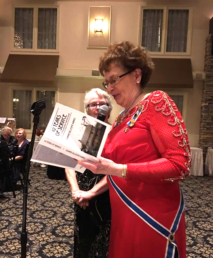 Corresponding Secretary holding a copy of her book